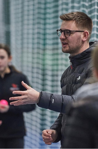 Cricket Wales coach talking to young players
