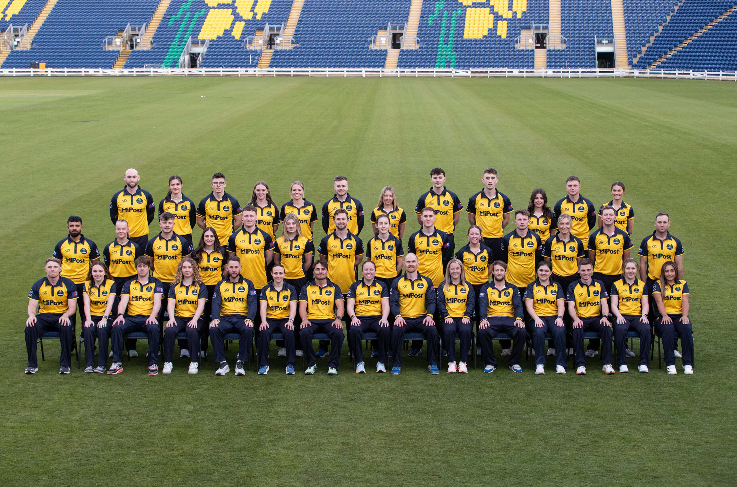 Glamorgan County Cricket Club mens and womens teams in kit posing for group photo